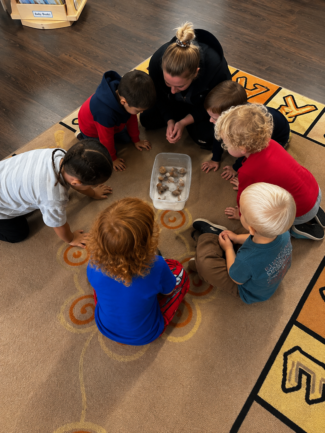 An educator supporting children during a small-group learning experience